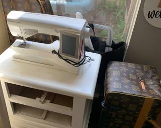 Viking sewing machine and carrying cases with attachments.