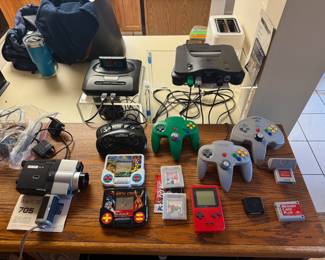 Wards Movie Camera, Gaming consoles and accessories including: Sega Genesis, Nintendo 64, Nintendo Game Boy, and handheld electronic games: Mighty Morphin Power Rangers and Mortal Kombat