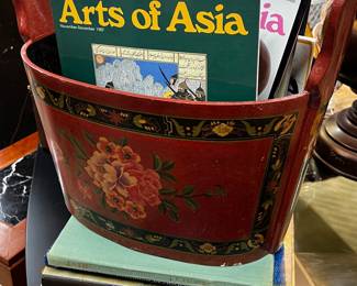 Asian art reference books in publications in a painted wooden bucket