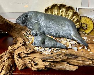Manatees on driftwood sculpture