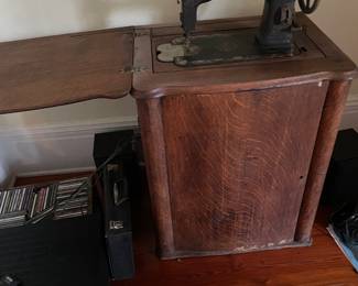 White Rotary sewing machine. Door opens to revel treadle and thread holder on door