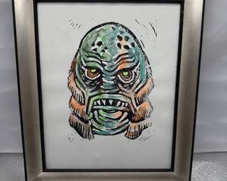 framed artwork featuring the Creature from the Black Lagoon, a classic Universal Studios monster
