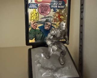 framed comic book cover, "Tales of Suspense" featuring Iron Man, alongside a pewter statuette of Iron Man