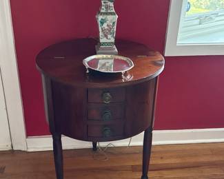 Mahogany Sheraton drum-shaped sewing table with 3 small drawers slender turned legs
American 22 ½” diameter circa 1825