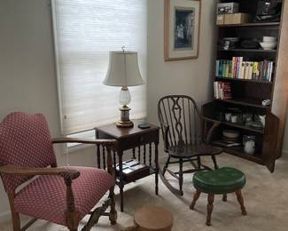 Fun chairs and small stools. Bookshelf with a nice set of Christmas dishes.