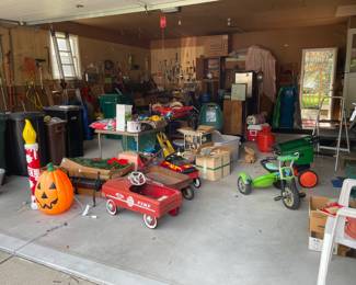 A garage, full of hand tools, yard tools, fishing/hunting equipment, storage cabinets, toys, and much more
