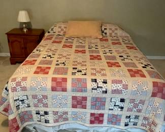 Nice bed with beautiful quilt