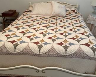 Very nice bed with vintage headboard and footboard that matches the dresser. Beautiful quilt.
