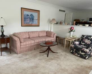 Nice couch, chair, tables, lamps, and wall art