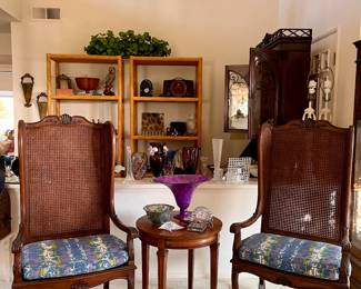 Pair of amazing wingback chair with cane back and removable cushion, On the table, a joined abalone fish and abalone-covered box sit near an art glass starfish, a crystal clock, a Chinese vase and a decorative purple glass vase.