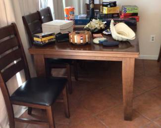 Dining table with 1 leaf & 4 chairs $225.; board games