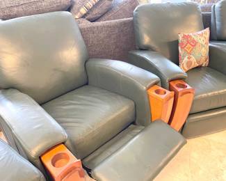 Three of the seats recline, and all feature two slide out wooden cup holders. Or drink and popcorn holders, we suppose :)