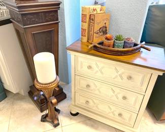 Lot of accent features like this white,3-drawer cabinet and candle stand that is almost as tall!