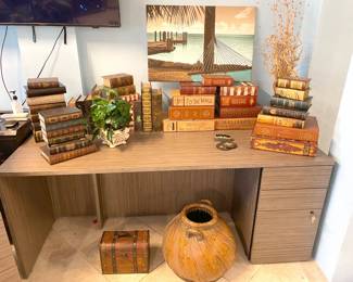 Good commercial grade desk (large) piled with fun, faux books ... each a clever little storage box.