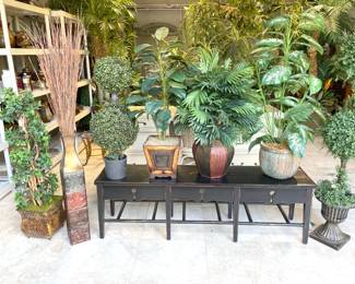 Love this long Asian-sh bench covered in high-quality faux plants with beautiful bases -- pots and baskets.