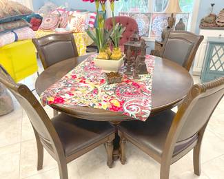 Basic, last-for-ever, solid wood dining pedestal table with comfy, high-back chairs.
