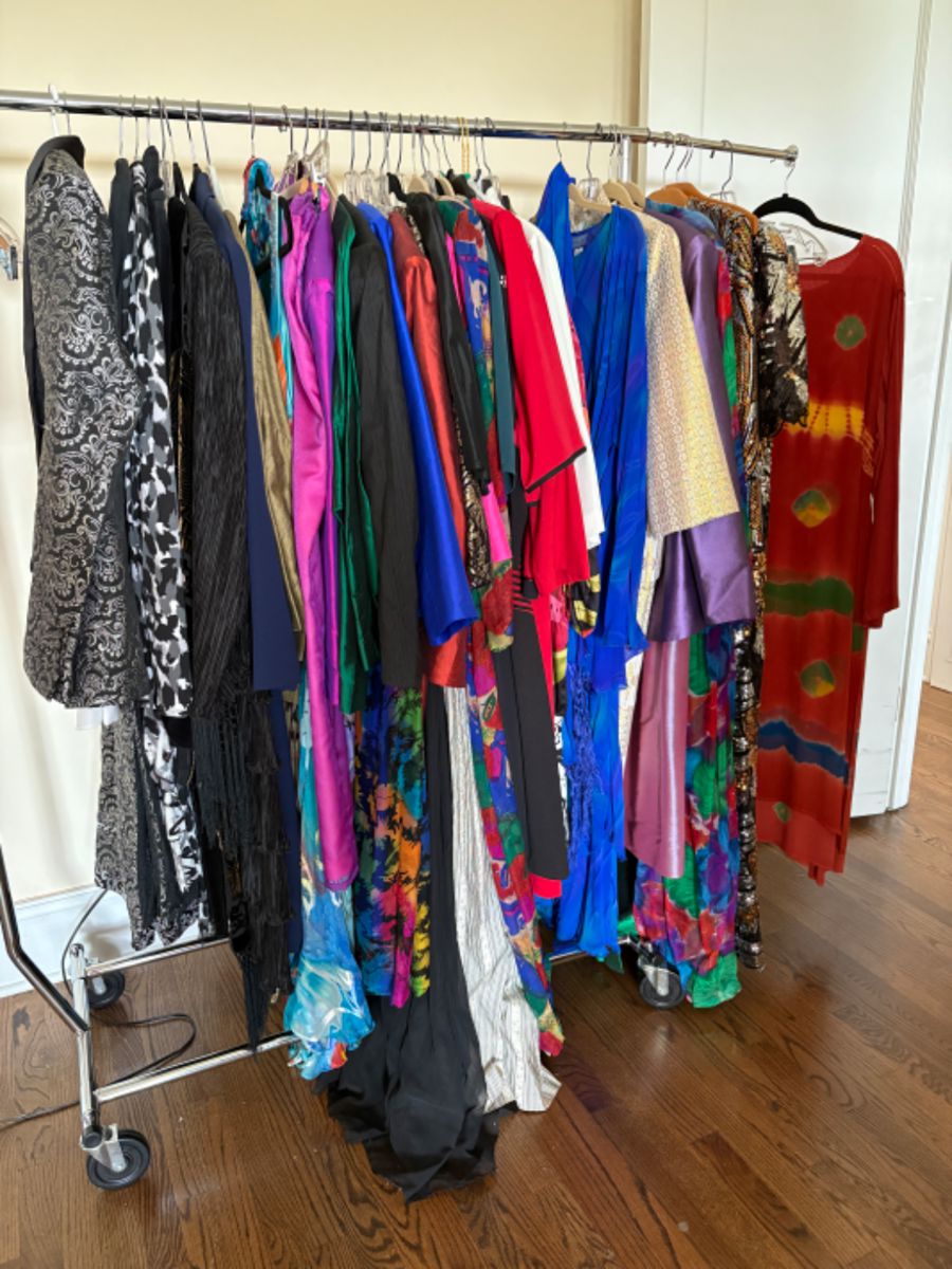 Lots and lots of women’s clothes, larger sizes, mostly 16-20 with some 12-14, some vintage clothing, lots of clothes from Asia, South America, Mexico, Africa and the Middle East, many bought on their myriad of travels, many are new with tags (never worn, at one point they were thinking of opening a store with imported ethnic and tribal clothing and purchased a lot of stock but never opened the store). There are 5 packed rails plus a huge walk in closet full of clothes.