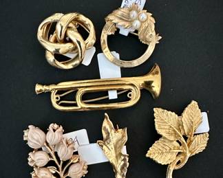 Gold and gold tone brooches