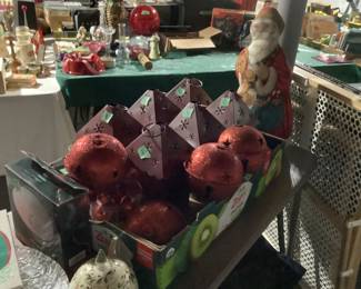 Christmas red large ornamental balls and luminary metal items.
