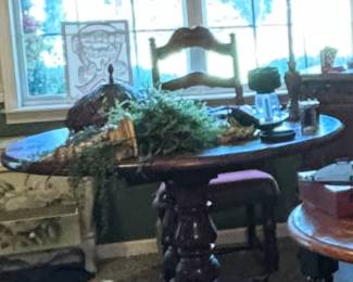 Great pedestal table. There are enough chairs scattered around to go around this table to make a set.