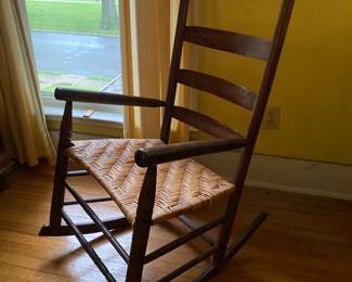 Shaker-style ladder back rocking chair with woven rush seat.