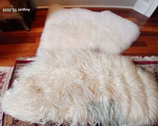 2 different Lamb skin rugs.