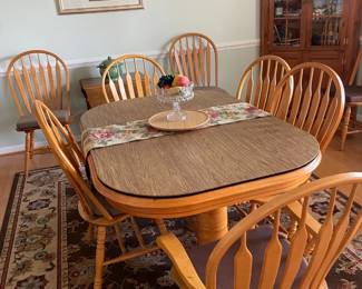 Wood dining table set with four side chairs and two arm chairs. The table measures approximately 30" high and extends to about 72" with the included leaf (all measurements are approximate and should be verified before buying). Comes with the leaf and a protective table pad, all for $300.