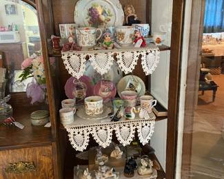Old cups with words and flowers, vintage glass dogs, floral plates, crochet shelf pieces 