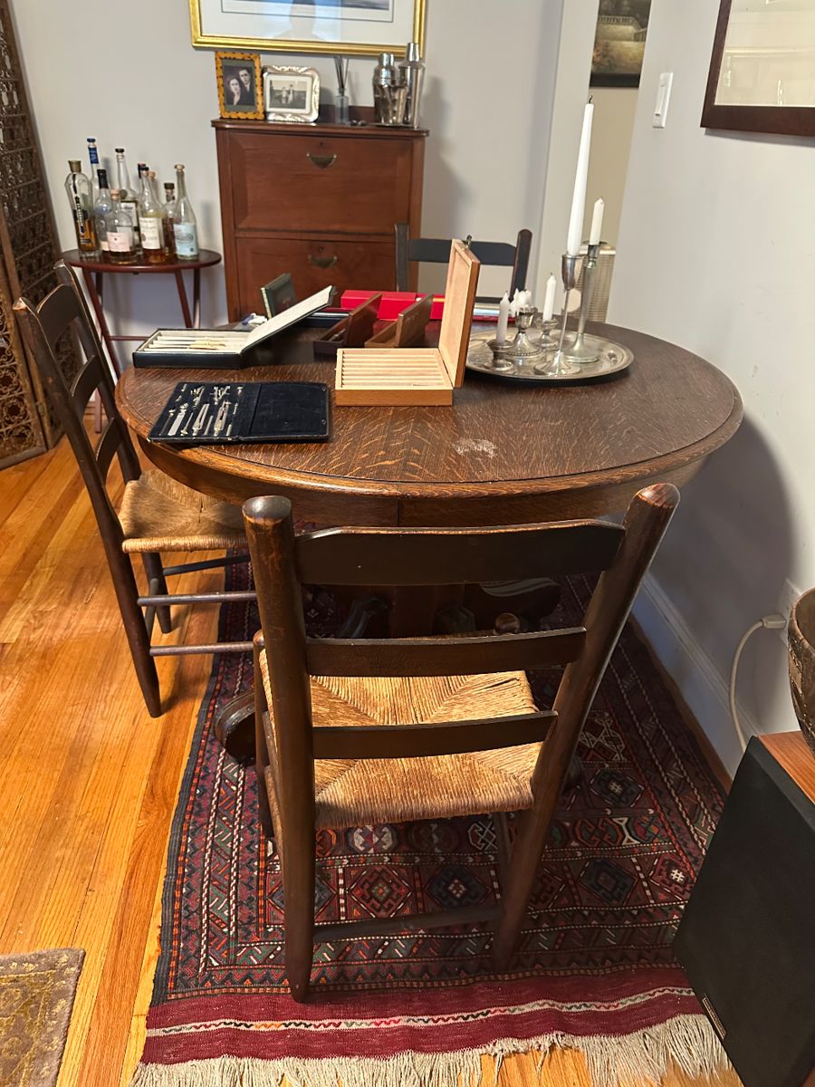 Antique dark wood round table with extra pair leaves and matching chairs