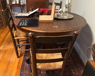 Antique dark wood round table with extra pair leaves and matching chairs 