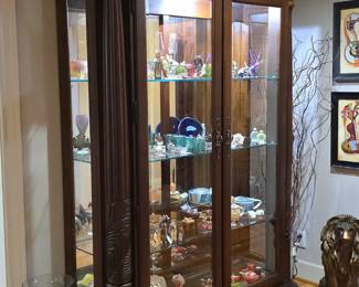 Museum-quality display cabinet with corner details and bright light.