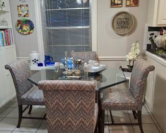glass-topped octagonal dining table with 4 chairs