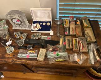 Waterford Crystal clock, glass door knobs, vintage boxed fishing lures, Indian head buckle belt buckle, knives