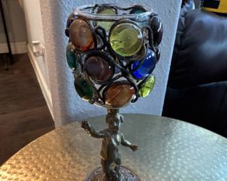 Colorful candle holder on cast angel base