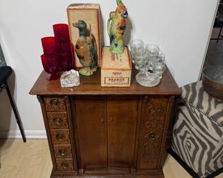 Antique sewing machine cabinet converted to bar.