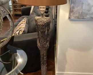 Floor lamp with slender man, a conversation piece