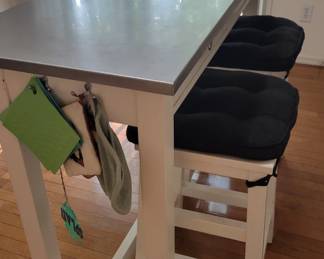 Free floating island with stainless steel top. 2 stools
