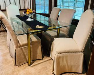Glass top dining table with six Parsons chairs
