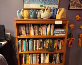 Bookcase with Haitian Art poster and Hall/McCoy ceramics