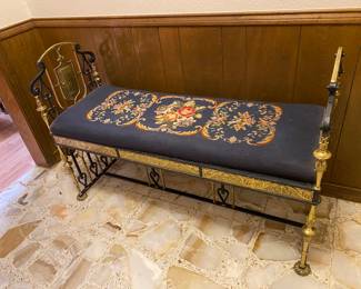 Wow! A beautiful bench perfect for your castle! It’s a heavy, wrought iron and brass bench with beautiful shield details and a beautiful embroidered seat. Could this be Spanish ?