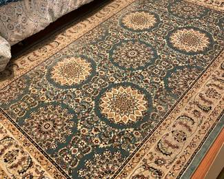There are numerous area rugs in this home. This one is a pretty turquoise color.