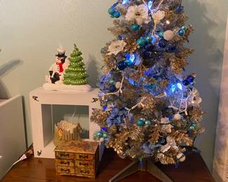 Gold tinsel and blue fully decorated Christmas tree