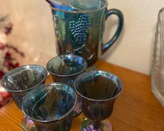 Blue carnival glass pitcher and glasses