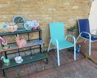 Metal and wood plant stand and patio chairs. Lots of handpainted, ceramic statues.
