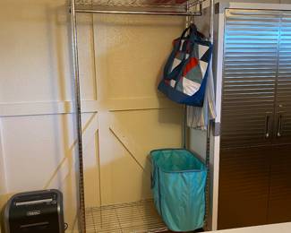 Clothing rack on wheels with extra storage. Space.