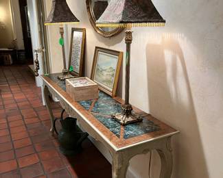 Sofa table(antique) ,  2 tall lamps, ornate mirror  