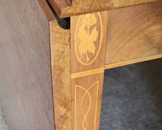 Inlaid details of drop leaf dining room table