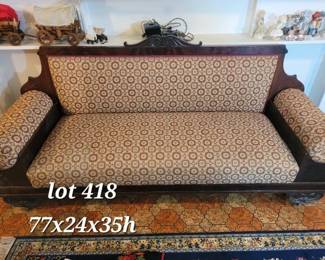 Antique empire sofa with carved wood details