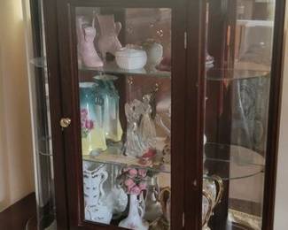 Wall curio cabinet includes collectible contents