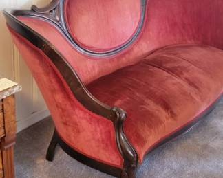 Carved Victorian red velvet settee